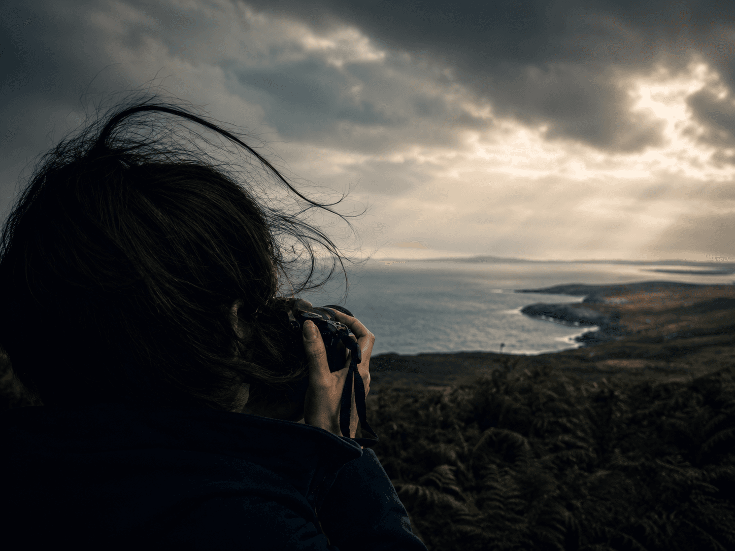 Out on the coast path, camera raised into the wind.